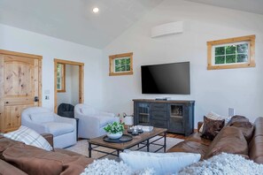Upper-level living area with smart TV, indoor fireplace, Deck, and stunning view of Flathead Lake!