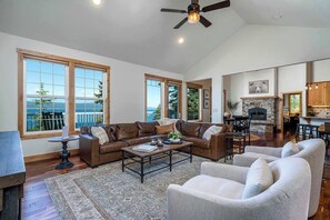 Upper-level living area with smart TV, indoor fireplace, Deck, and stunning view of Flathead Lake!