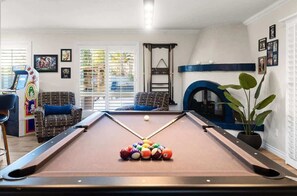Game lovers will feel right at home with this billiard table and arcade games.