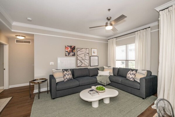 Living Room Space w/ Smart TV & Pull Out Queen Sofa Bed