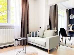 Unwind in this bright, stylish living space — perfect for lounging or planning your day. Curious about Smart TV options? Just ask!