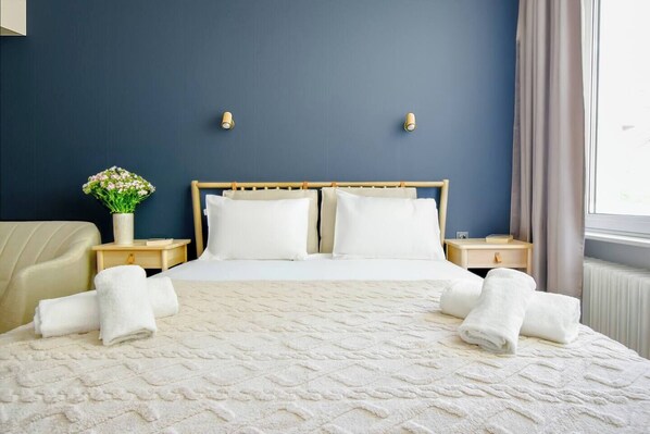 Rest easy in this bright, elegant bedroom with soft linens and a cozy vibe. Need anything extra for your stay? Message us anytime!