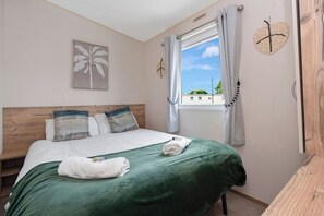 Charming bedroom with a cozy double bed, soft linens, and a relaxing atmosphere—perfect for a restful night.