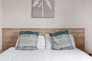 Comfortable and stylish bedroom with a plush double bed and soft, inviting decor—ideal for a peaceful night’s sleep.
