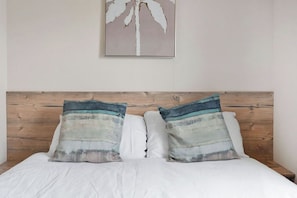 Comfortable and stylish bedroom with a plush double bed and soft, inviting decor—ideal for a peaceful night’s sleep.