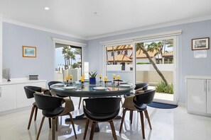 Fully equipped indoor kitchen with stainless steel appliances, island seating for 6, and dining space for 8—ideal for family meals and entertaining.