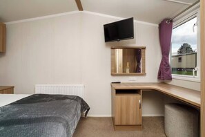 Enjoy your own peaceful corner with a comfy bed, smart TV, and a bright workspace by the window—perfect for both relaxing and unwinding.