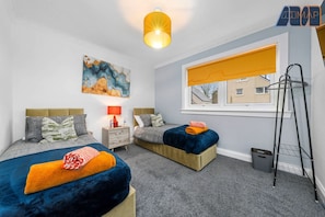 A bright and stylish bedroom featuring two zip-link single beds, perfect for flexibility and comfort.