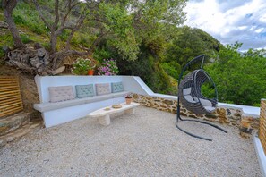 The spacious terrace borders the countryside.