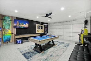 game room space, seating, and classic arcade games