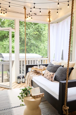 Curl up in the hanging daybed for a dreamy nap, a good book, or late-night chats under twinkling lights.