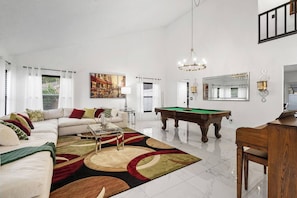Experience the comfort of a bright, airy living room with high ceilings and a perfect blend of space