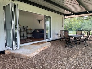 Folding glass doors open onto covered patio