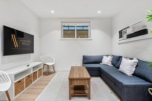 Living room with a Smart TV and a cozy sectional with a pull-out sleep sofa (all bedding provided!)
