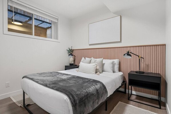 The bedroom features a queen bed, closet & room-darkening shades.