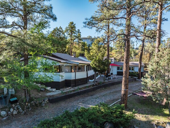 Nestled among towering pines, this peaceful Prescott retreat offers rustic charm with modern comforts. Enjoy quiet mornings on the deck, afternoon gatherings under the gazebo, and evenings making memories playing shuffelboard, bumper pool or arcade games. Just minutes from Thumb Butte and Courthouse Square—your cozy getaway awaits!