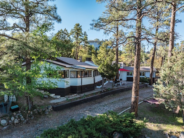 Nestled among towering pines, this peaceful Prescott retreat offers rustic charm with modern comforts. Enjoy quiet mornings on the deck, afternoon gatherings under the gazebo, and evenings making memories playing shuffelboard, bumper pool or arcade games. Just minutes from Thumb Butte and Courthouse Square—your cozy getaway awaits!