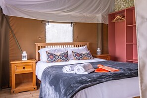 King- size master bedroom with water bottles