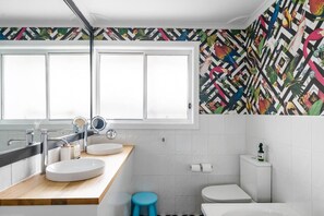 Bold, bright, and stylish—this vibrant bathroom adds a splash of fun to your stay! By Superhostly