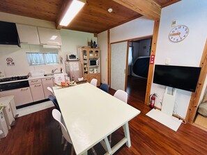 Spacious living/dining room with furniture and appliances. High-speed Wi-Fi available.