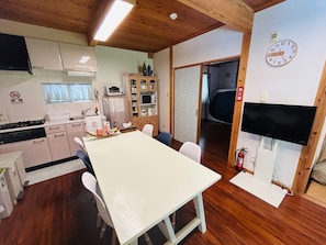 Spacious living/dining room with furniture and appliances. High-speed Wi-Fi available.