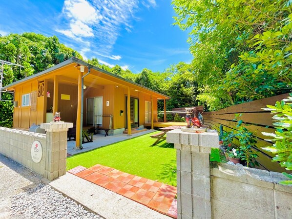 A cute, old-style, single-story house. Parking is available for up to three cars.