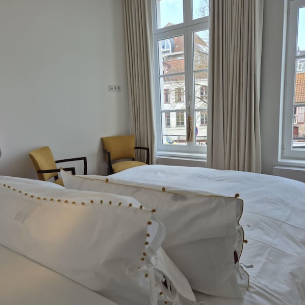 Spacious bedroom with double bed and city view
