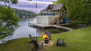 Firepit with seating next to boathouse