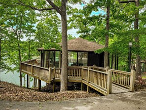 The distinctive "treetop" design of Unit 20, with its charming deck and convenient ramp access, blending seamlessly into the natural landscape.