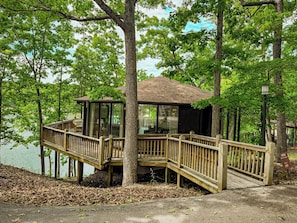 The distinctive "treetop" design of Unit 20, with its charming deck and convenient ramp access, blending seamlessly into the natural landscape.