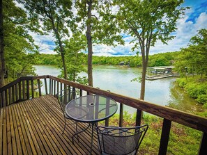 Savor your morning coffee or evening cocktails on the private deck of Unit 20, offering stunning views of the tranquil lake and surrounding nature.