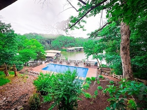 Nestled among the trees with stunning lake views, this serene pool is one of two exclusive lakefront pools available to Treetop Villa guests.