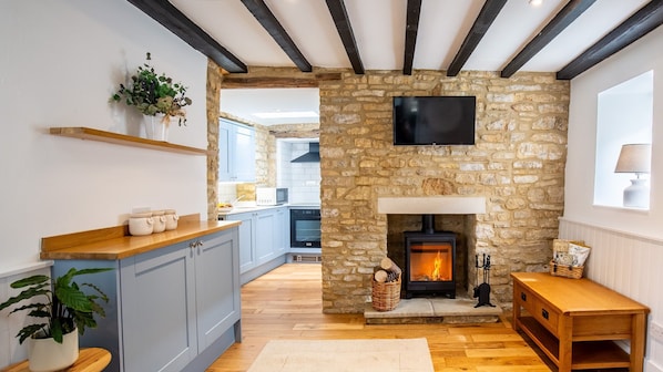 The inviting living room features a warming log burner
