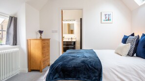 The cosy bedroom is light and airy