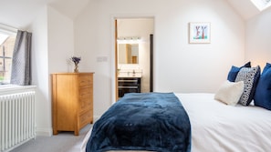 The cosy bedroom is light and airy