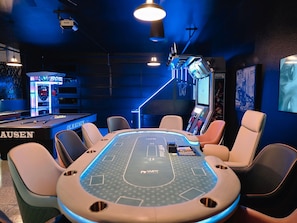 Ultimate game room with Vegas style poker table with 10 leather chairs.