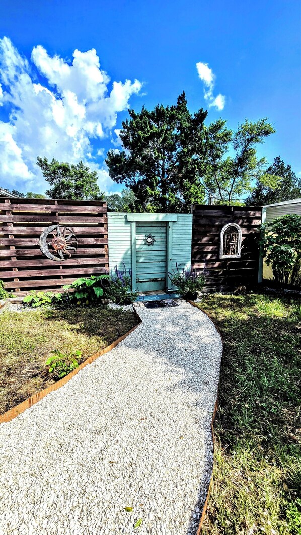 Front of house, entrance into gardens/back yard