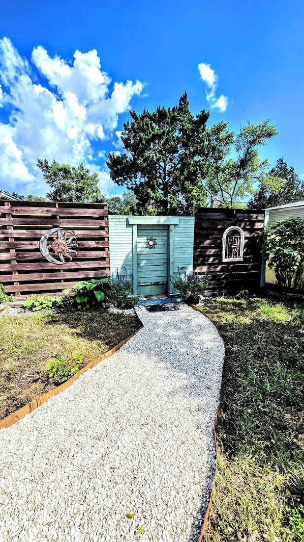 Front of house, entrance into gardens/back yard
