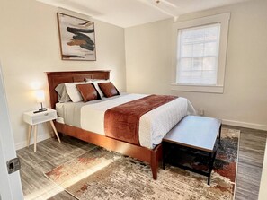 Hybrid Queen size bed. Night stands on both sides, lamps with outlet for charging, suitcase bench, dresser, closet and Smart TV