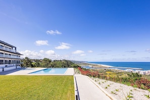 2-bedroom apartment in Pederneira with sea view balcony, pool, and peaceful setting, just minutes from Nazaré beach and town center.