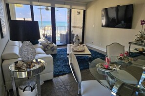 Modern Sleek Furniture for relaxing, along with a large flat screen TV. 