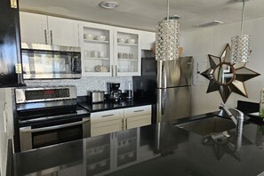 The updated kitchen is complete with new stainless steel appliances.