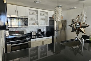 The updated kitchen is complete with new stainless steel appliances.