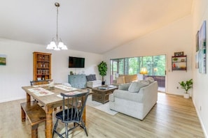 Spacious open living and dining area with Smart TV, books and board games.