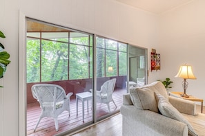 spacious living room leads to screened in back porch.