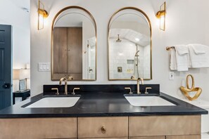 Primary en-suite bathroom with dual vanity and walk in shower