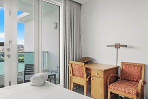 Cozy workstation by the balcony doors, offering a perfect blend of work and views.