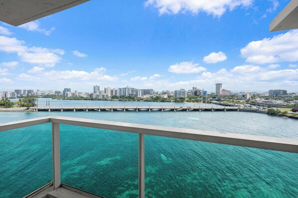 Private balcony with glass railings, showcasing breathtaking lagoon and city vistas