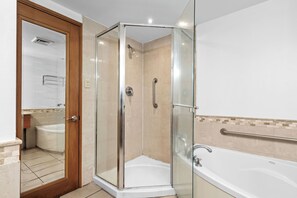 Spacious and functional bathroom offering a large mirror, ample counter space, and modern fixtures.