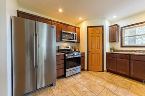 Kitchen - Fully equipped kitchen with refrigerator, range and dishwasher